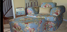 blue floral slipcovered chair and ottoman